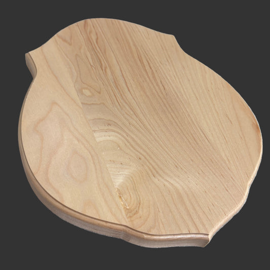 Wooden coaster on a desk with a laptop and other items in the background